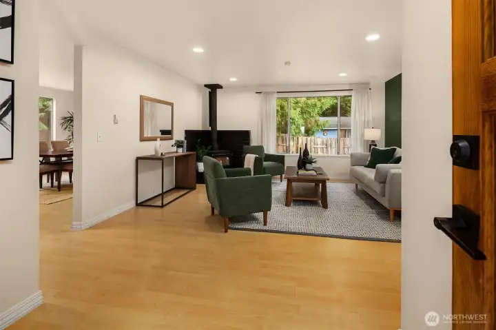 Front door opening into living room with seamless flow into kitchen.