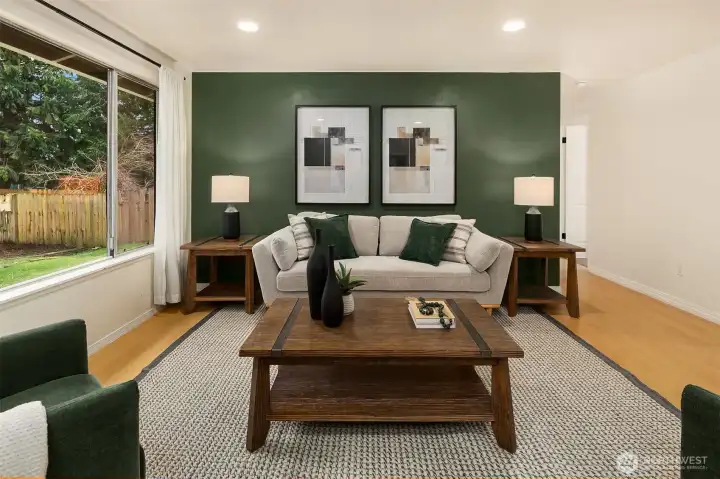 Spacious living room seamlessly flowing to both wings of the home.