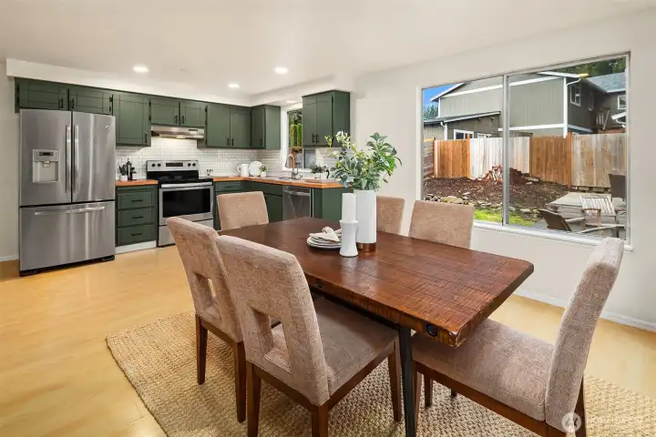 Dining room seamlessly flowing into spacious kitchen.