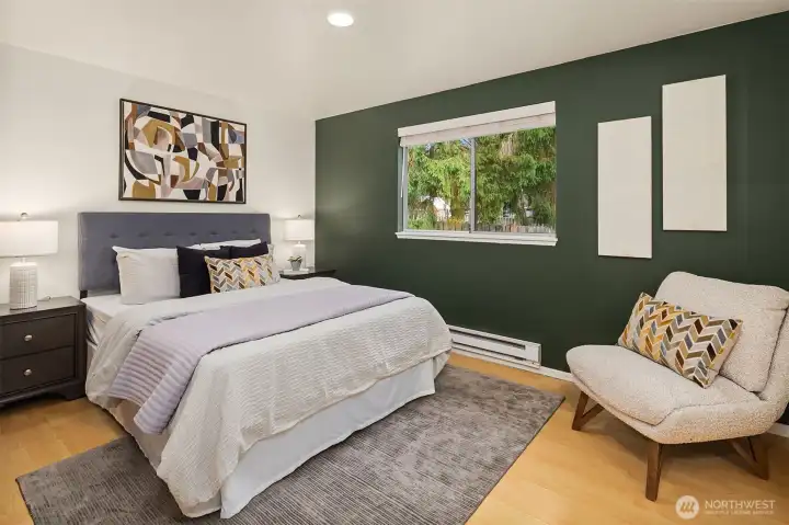 Primary bedroom with large window.