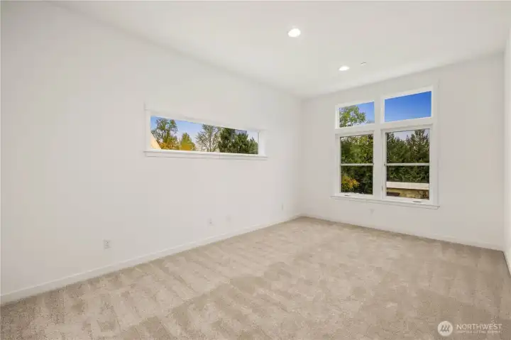 This open bonus loft on the upper level offers a bright, flexible space ideal for a media area, play zone, or secondary lounge. Large windows bring in natural light and frame neighborhood views, making it an easy place to gather, work, or unwind.    These photos are from lot 3 at Gooden Hollow, the actual home for sale. However, other homes may vary, so all photos, renderings, site maps, and floorplans are for visualization purposes only. Plans, colors, building orientation, finishes, home outlook, and other details can and WILL vary.