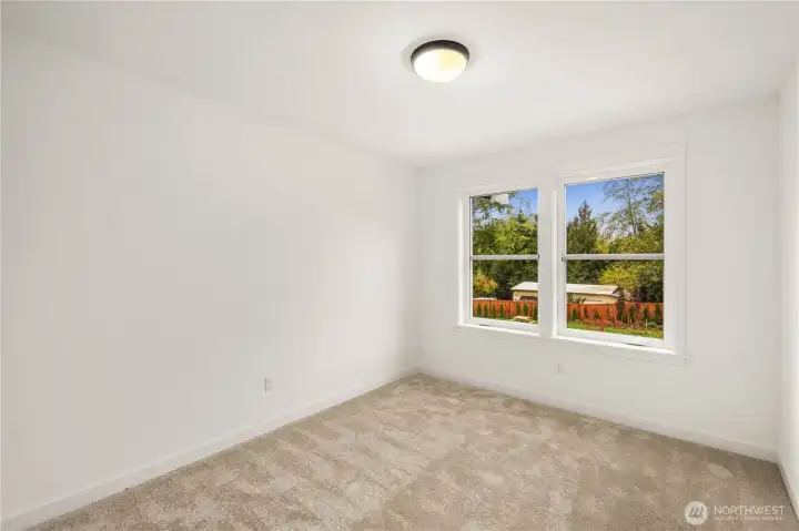 A comfortable upper-level bedroom with soft natural light, plush carpeting, and a simple, flexible footprint. It’s well-suited for a bedroom, office, or guest space depending on your needs.    These photos are from lot 3 at Gooden Hollow, the actual home for sale. However, other homes may vary, so all photos, renderings, site maps, and floorplans are for visualization purposes only. Plans, colors, building orientation, finishes, home outlook, and other details can and WILL vary.