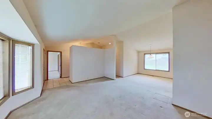 Corner of living room looking back at entrance. Primary bedroom to the left. Dining room to the right.