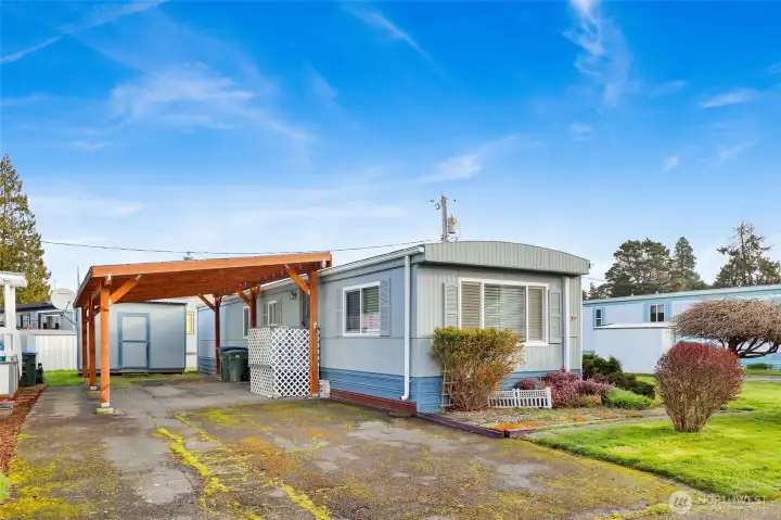 Welcome to your tall sturdy carport. The storage shed is spacious and handy. There's enough covered room for recycling & garbage, parking and your projects. Extra paved parking for additional vehicles on site and allowed on street.