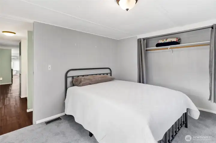 Main bedroom with big closet with curtains. This also hides a panel to access the hot water heater.