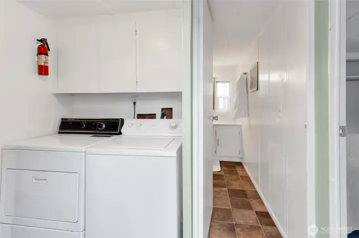 The laundry area is between the bedrooms next to the bathroom and back door.