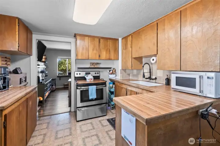 The kitchen with small eat in bar area and a galley dining space to sit down and enjoy a meal.