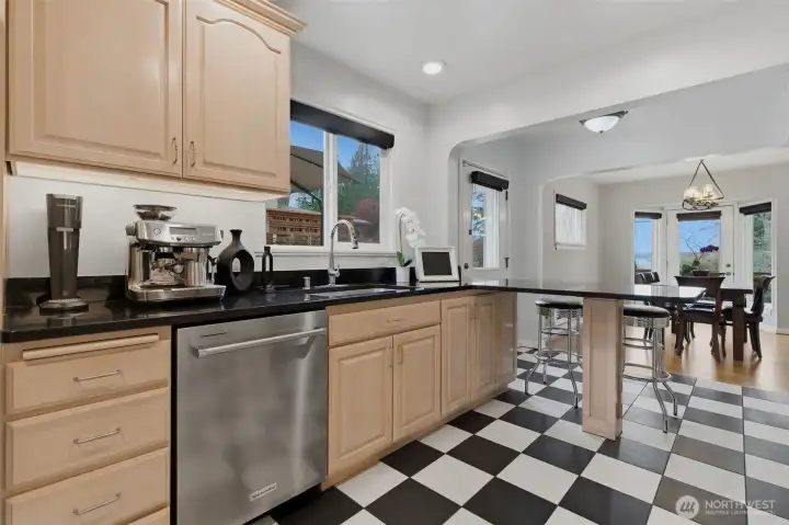 Renovated kitchen with granite counters, heated floors and stainless steel appliances.