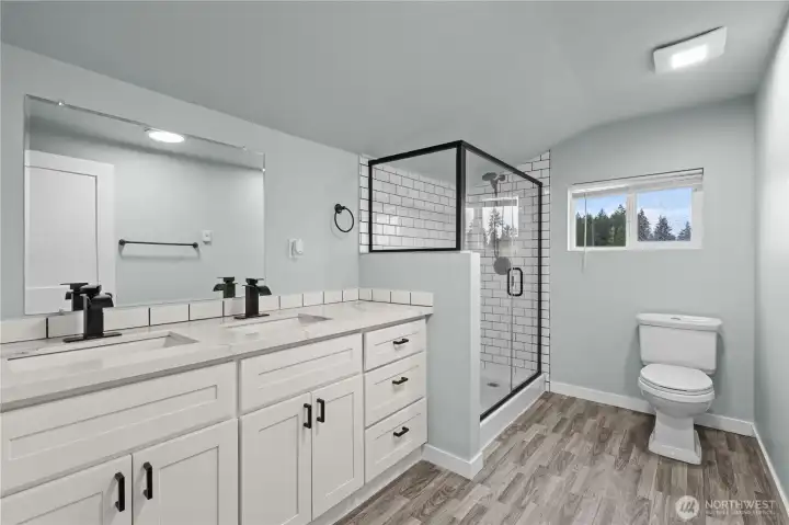 Upstairs bathroom with double vanity and walk in shower.