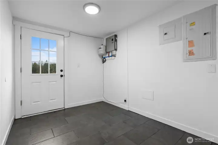 Mud room leads to separate fenced back yard, perfect for a dog run.