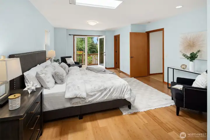 Primary bedroom overlooking private balcony with park like views.