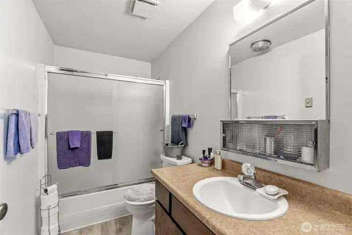 Beautifully refreshed full bathroom complete with modern new lighting and crisp paint