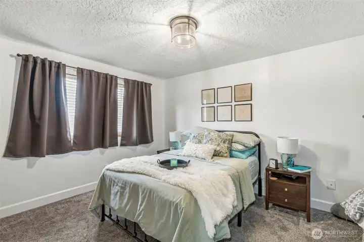 Bedroom #1 showcases the same high-quality updates found throughout, complete with new flooring, fresh paint, and modern lighting.
