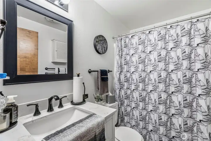 Fully remodeled full bathroom complete with a modern new vanity, updated plumbing fixtures, and stylish new lighting.