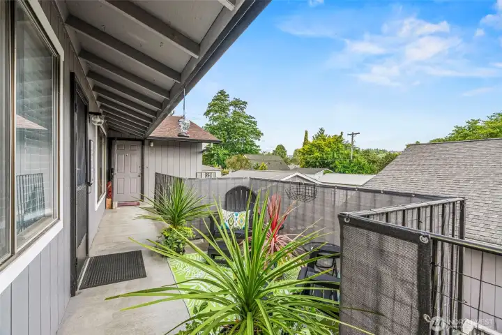 Charming upstairs walkway featuring a versatile sitting area, perfect for a reading nook or quiet workspace