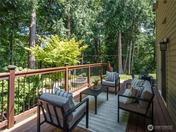 Extend your living space outdoors on the expansive deck, thoughtfully designed for relaxing, entertaining, and dining while overlooking the beautifully landscaped backyard and tranquil, tree-lined surroundings. Extend your living space outdoors on the expansive deck, thoughtfully designed for relaxing, entertaining, and dining while overlooking the beautifully landscaped backyard and tranquil, tree-lined surroundings.