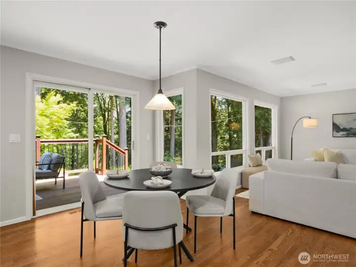 Enjoy everyday meals with a view in the bright dining area, where expansive windows and sliding glass doors fill the space with natural light and provide seamless access to the entertaining deck. Enjoy everyday meals with a view in the bright dining area, where expansive windows and sliding glass doors fill the space with natural light and provide seamless access to the entertaining deck.
