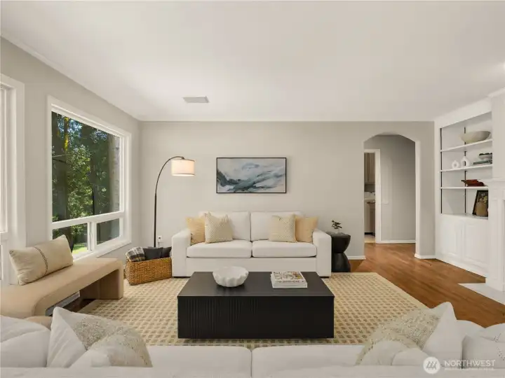 Comfort meets timeless design in this light-filled great room, where expansive windows frame serene woodland views and custom built-ins add both character and function. Comfort meets timeless design in this light-filled great room, where expansive windows frame serene woodland views and custom built-ins add both character and function.