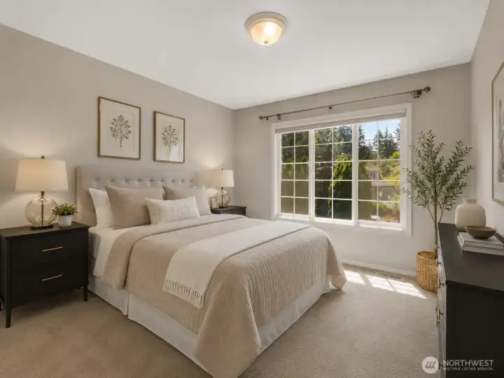This bright and spacious bedroom is faces the front of the home. Large windows fill the space with natural light, creating a warm and inviting retreat. This image has been virtually staged using AI. Furniture and décor are for illustrative purposes only. This bright and spacious bedroom is faces the front of the home. Large windows fill the space with natural light, creating a warm and inviting retreat. This image has been virtually staged using AI. Furniture and décor are for illustrative purposes only.
