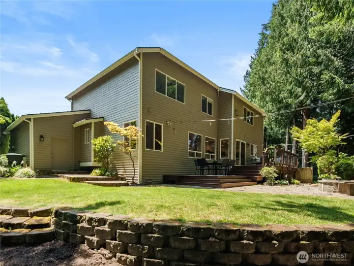 A private backyard sanctuary unfolds with an expansive deck, stone fire pit patio, manicured lawn, and towering evergreens—creating an exceptional setting for entertaining, relaxing, and enjoying the beauty of every season. A private backyard sanctuary unfolds with an expansive deck, stone fire pit patio, manicured lawn, and towering evergreens—creating an exceptional setting for entertaining, relaxing, and enjoying the beauty of every season.