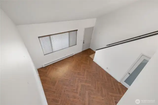 From the upper floor overlooking the living room and its vaulted ceiling