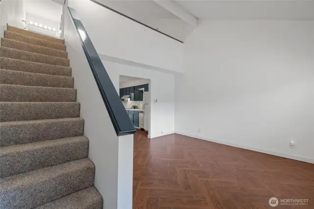This cozy abode welcomes you with a vaulted ceiling and open concept layout