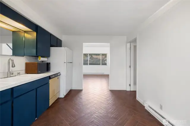 Another view of the kitchen showing the storage room on the right and the living room straight ahead