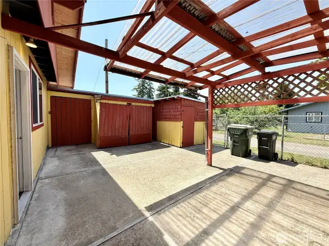 Covered side patio with enough room for a hot tub; which is prewired.