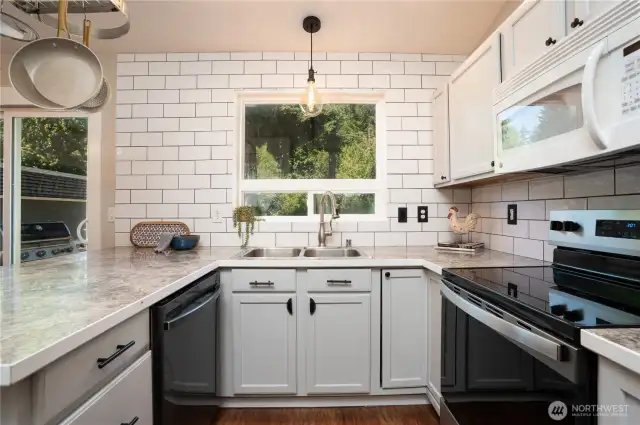 Delight in this fun and fresh kitchen with custom subway tile backsplash, new range & newer dishwasher!