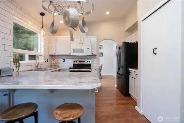 Belly up to the bar as your favorite chef prepares the perfect meal! Loads of counter space & updated lighting are nice features that this charming kitchen offers.