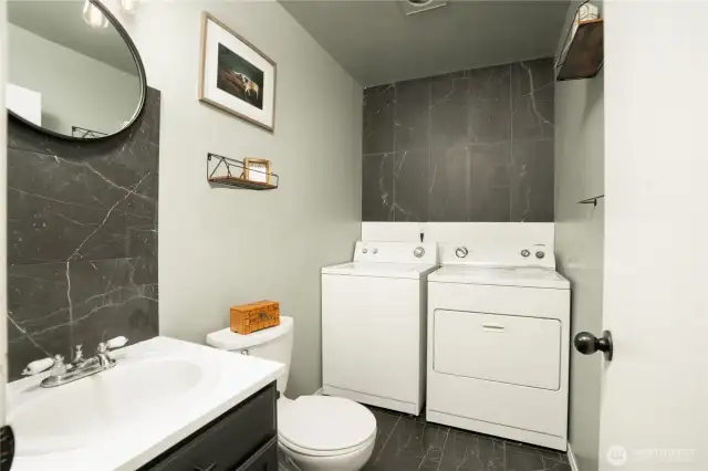 Utility room - 1/2 bath combo, with matching custom tile flooring, accent wall and backsplash. Washer & Dryer convey with home.