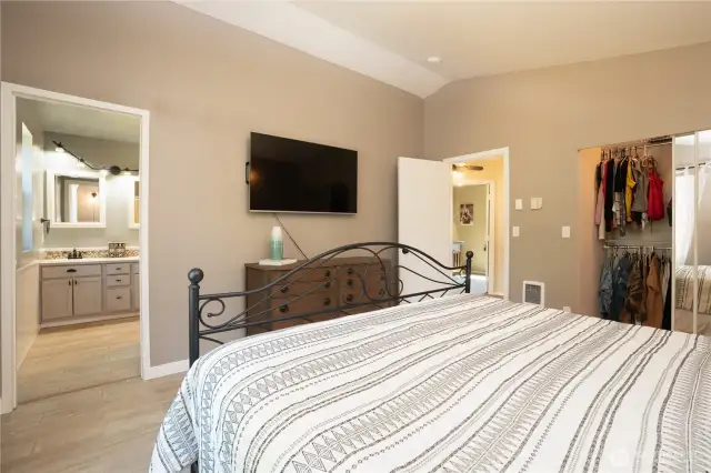 Complete view of primary en suite with 4 piece bathroom and adequate sized closet.