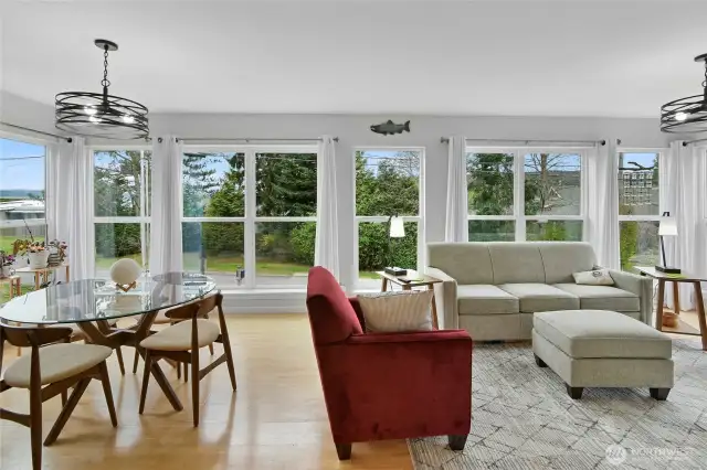 Well lit great room with dining space, comfy insert  and updated light fixtures.