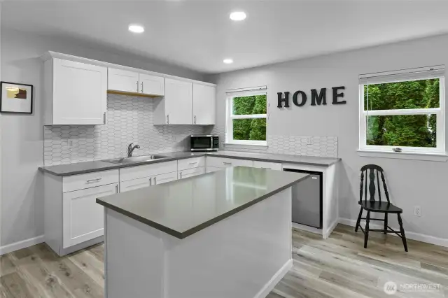 Another view of the nicely updated partial kitchen with lots of storage used for arts and crafts.