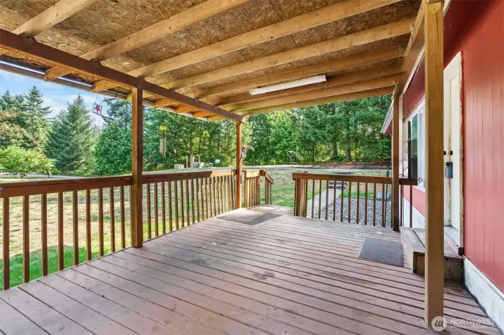 Covered porch with paved walkway.