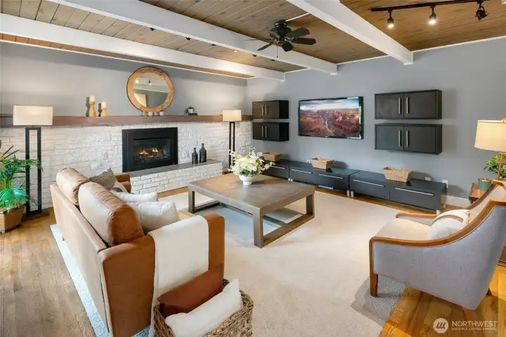 Living room features new carpet, hardwoods, gas fireplace, and built-in shelving which remains.