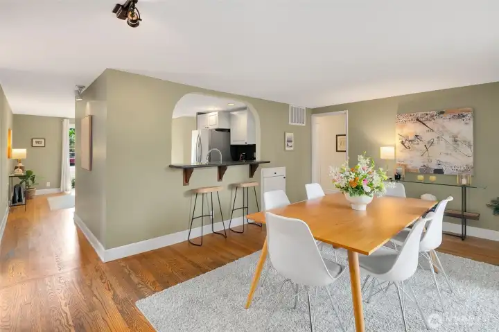 Formal dining with breakfast bar to the kitchen and sliding doors to the backyard deck.