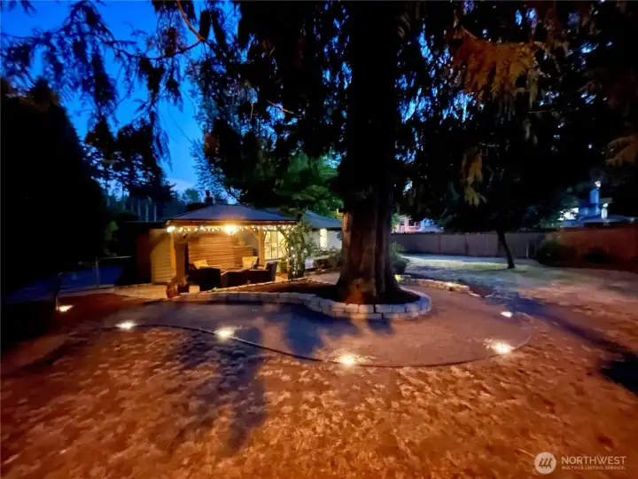 Beautiful landscaped lot with cedar and maple trees.