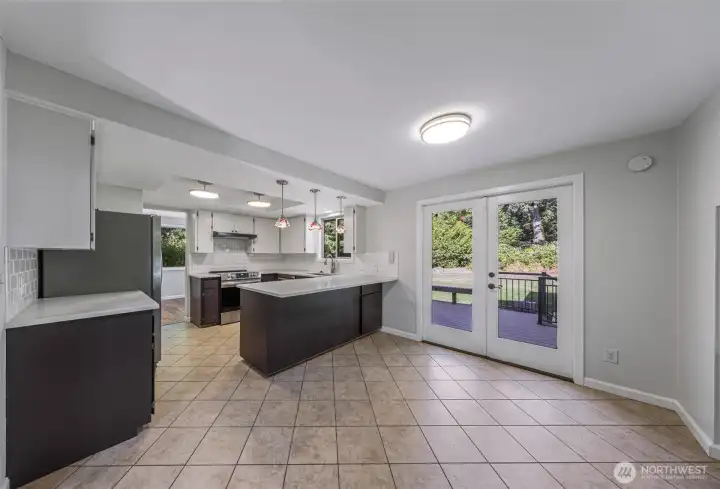 Kitchen with eating bar, new lighting, counters,sink and tiled floors and table space