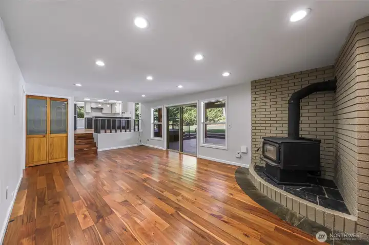 Lower level living room with stunning flooring, real wood stove, access to garage and Chalet covered back patio