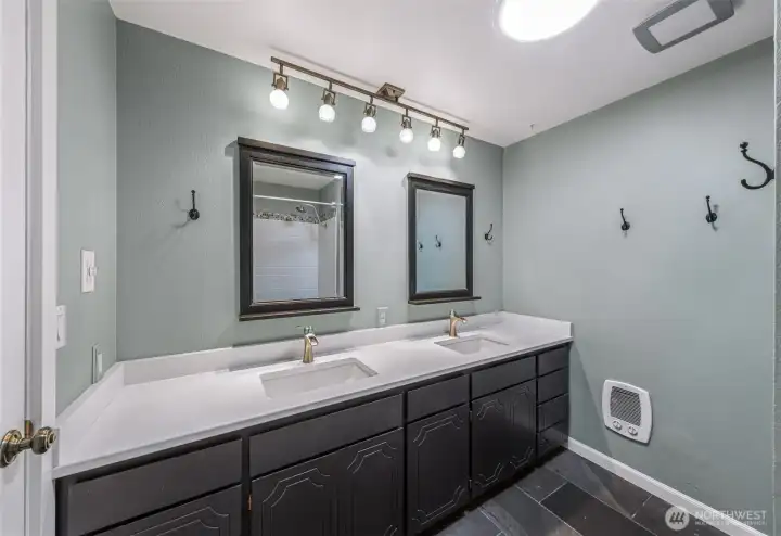 upper level full bathroom with new dual sink vanity, lighting and tiled floors