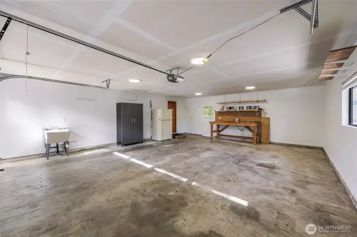 huge two car garage with door access to back yard, hot tub and shed
