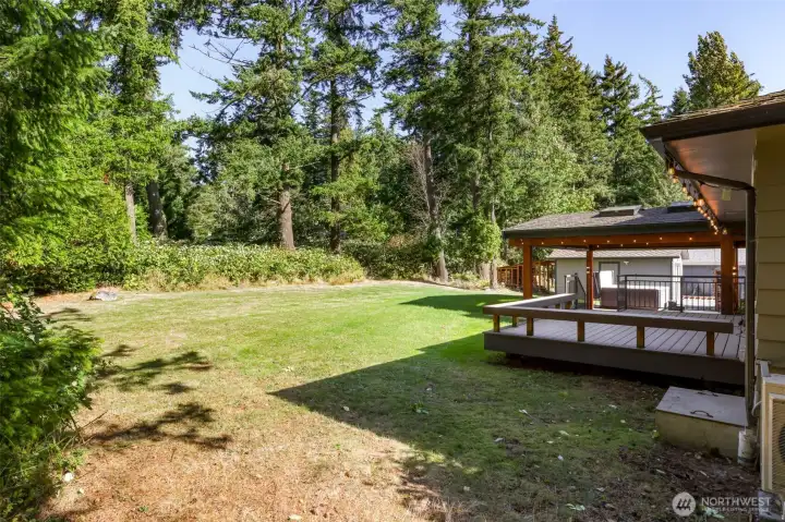 GRAND chalet style covered patio with stained concrete, skylights and powered lights and plugs next to the large hot tub