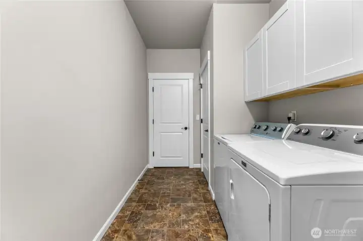Laundry room with lots of storage that leads out to the 3 car garage