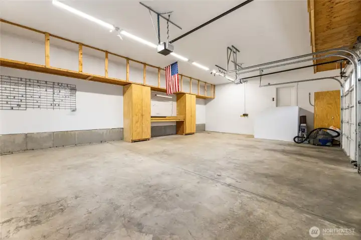 3 car garage with built in shelving, 11 foot ceilings and newer bright lights