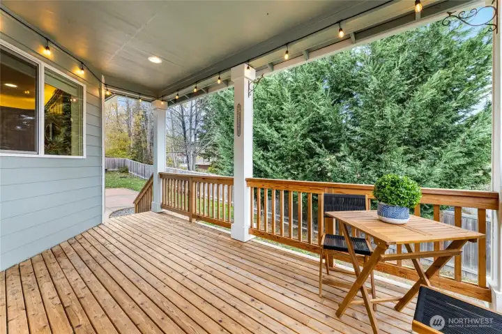 Covered deck off the dining and kitchen. Stairs take you out to the large patio