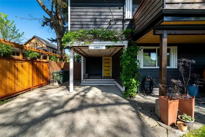 Enter the home through the cheery yellow door in the carport.