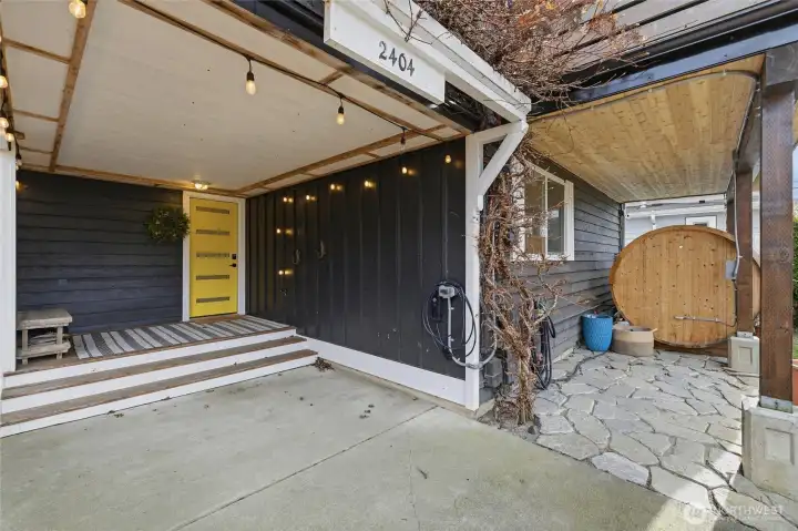 Enter the home through the cheery yellow door in the carport