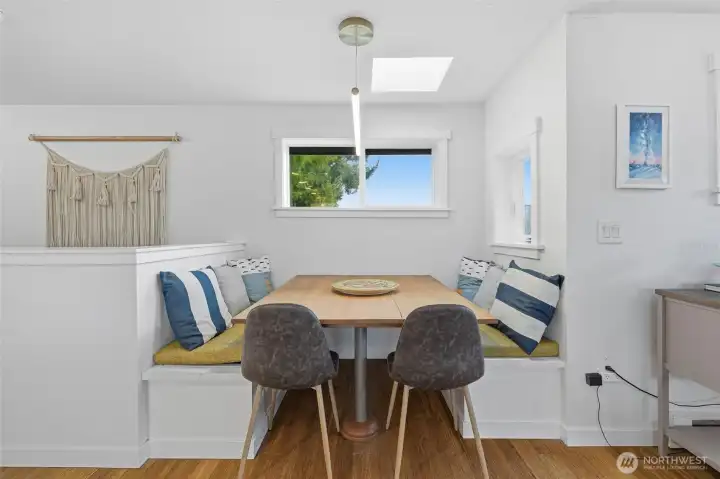 There is a large built in dining table nook right next to the kitchen.