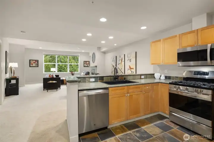 The kitchen features all stainless, newer appliances including a gas range.